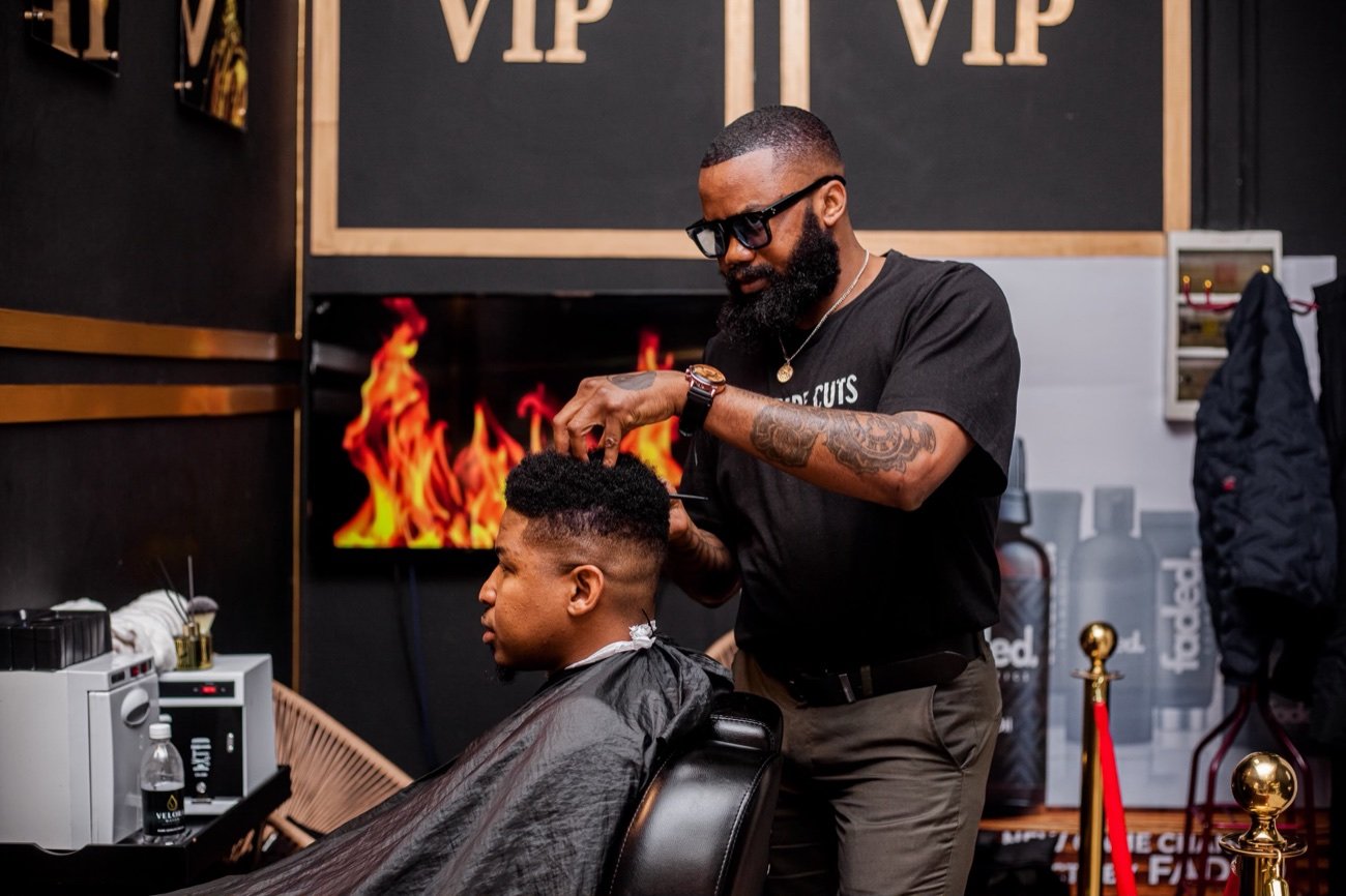 Master barber giving a fade in the VIP lounge