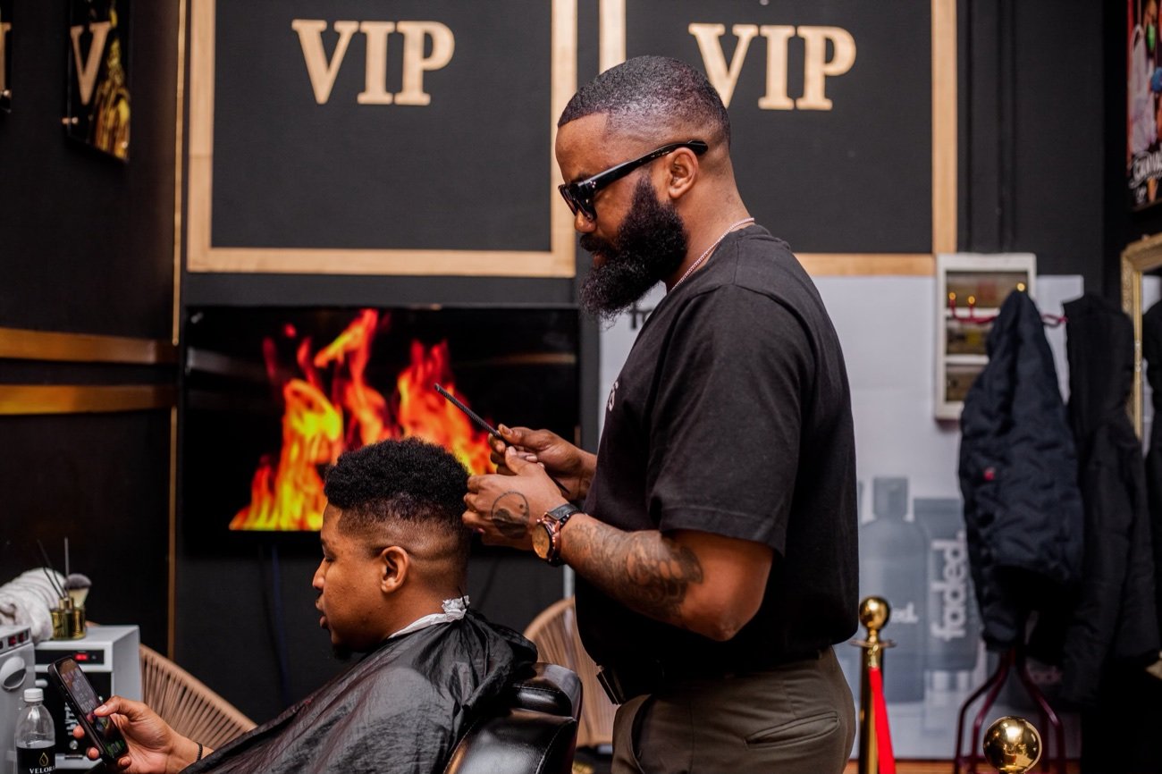 Barber cutting by the fireplace VIP wall